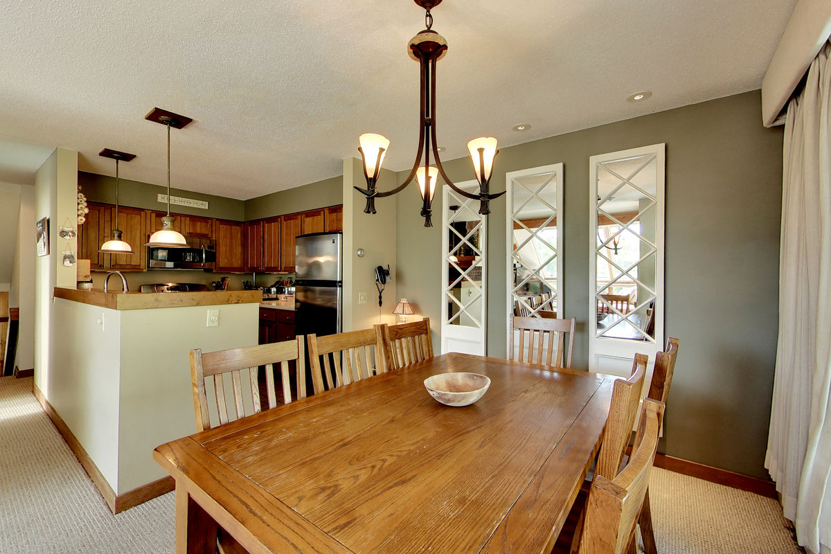 Dining Table and Chairs Next to the Kitchen in Our FlipKey Killington Rentals.